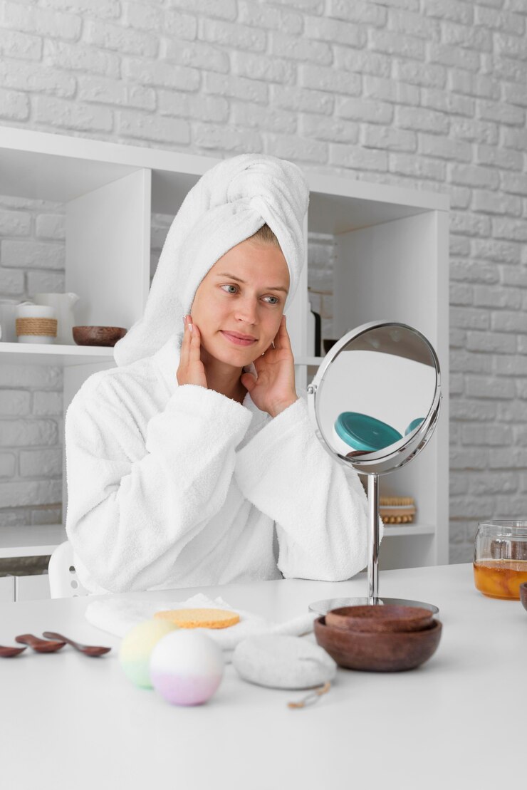 Free Photo low angle woman looking in the mirror
