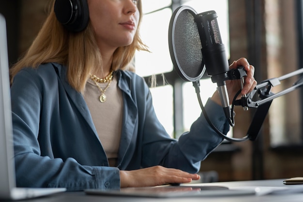 Low angle woman making podcast