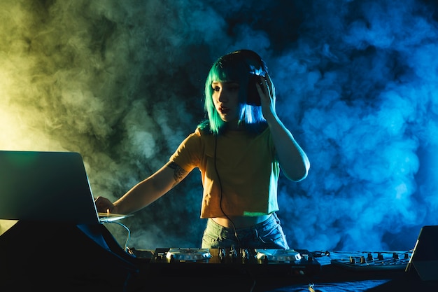 Free photo low angle woman mixing in club mock-up