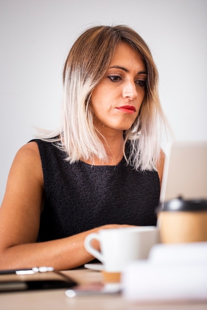 Free photo low angle woman at office working