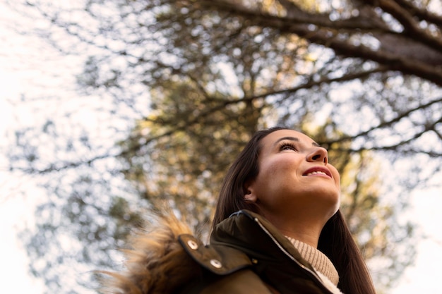 Free photo low angle of woman outdoors in nature