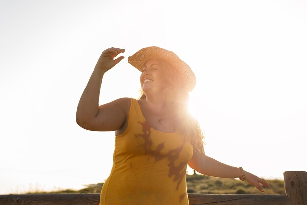 Low angle of woman outdoors with hat