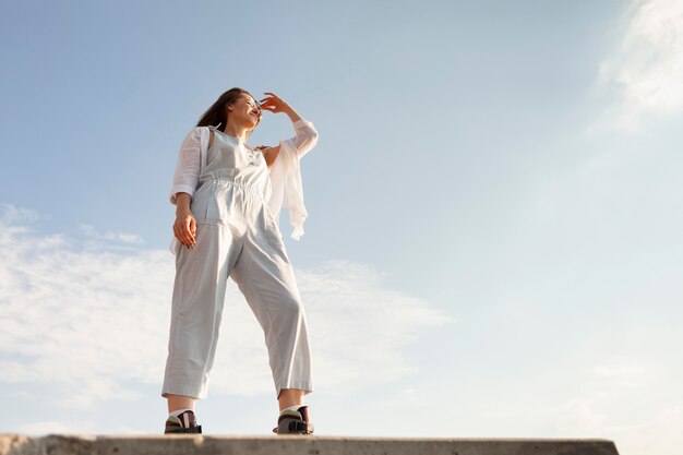 Low angle of woman posing outdoors with copy space