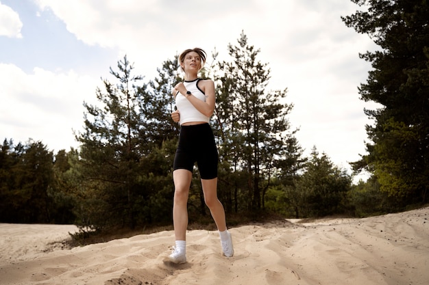 Low angle woman running in nature