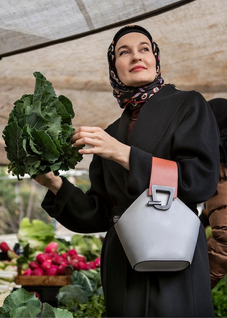 Free photo low angle woman shopping for ramadan