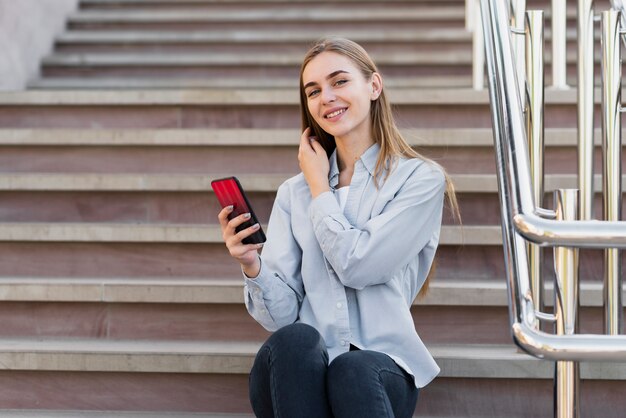 Low angle woman sitting on stairs