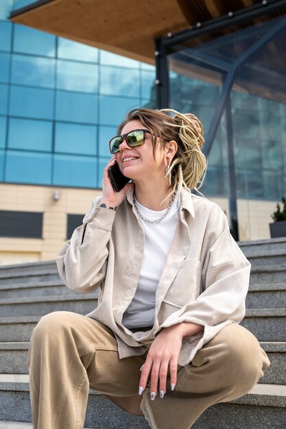 Low angle woman sitting on stairs