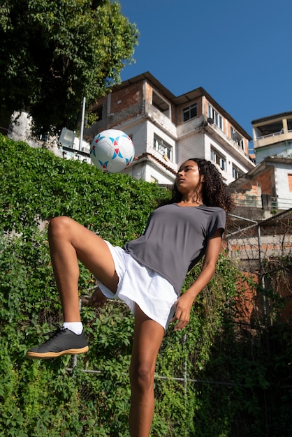 Free photo low angle woman on soccer field