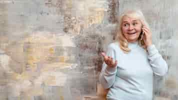 Free photo low angle woman standing next to frozen window