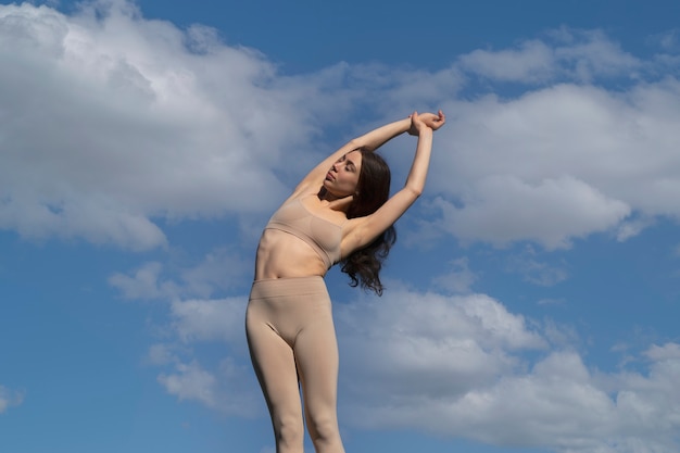 Low angle woman stretching arm