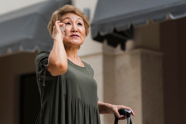 Free photo low angle woman talking on phone