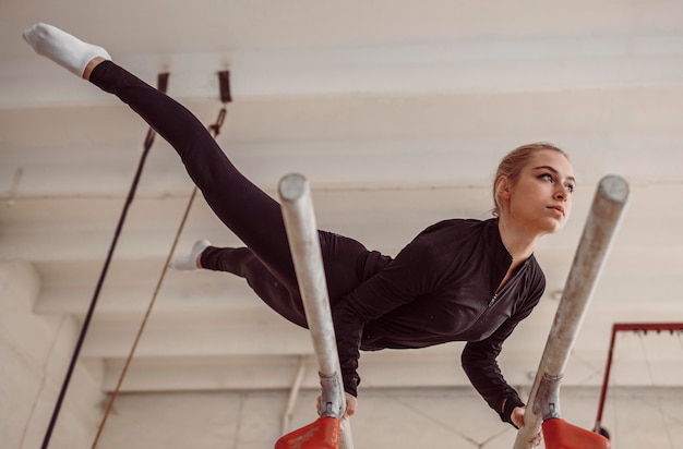 Low angle woman training for gymnastics championship