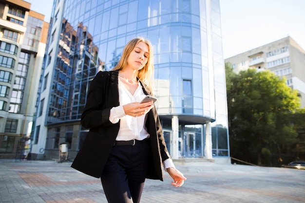 Low angle woman walking away from building