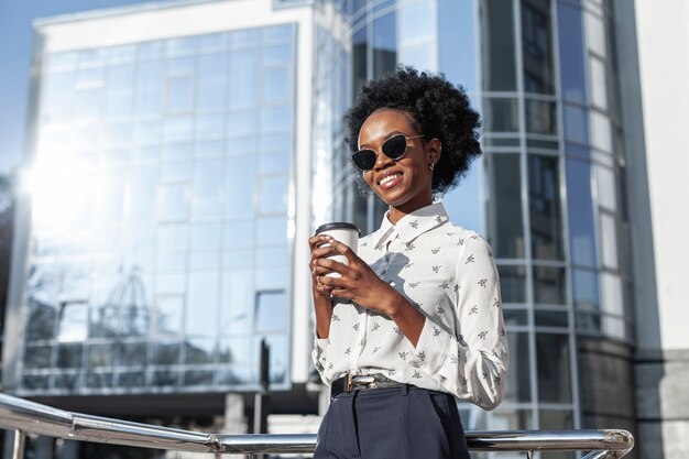 Low angle woman with coffee on balcony