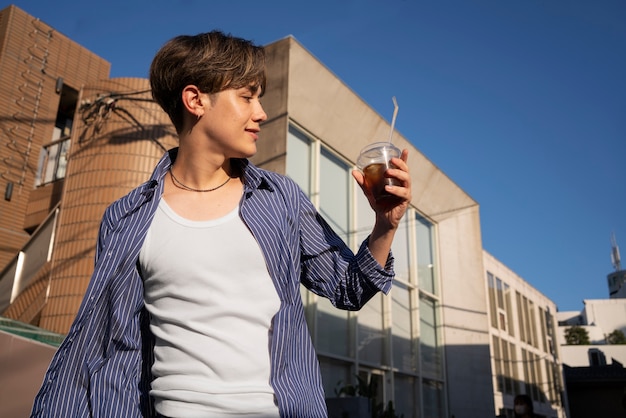 Low angle woman with iced coffee