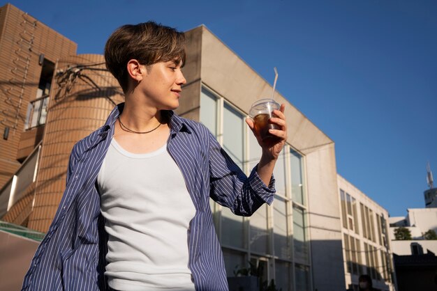 Low angle woman with iced coffee