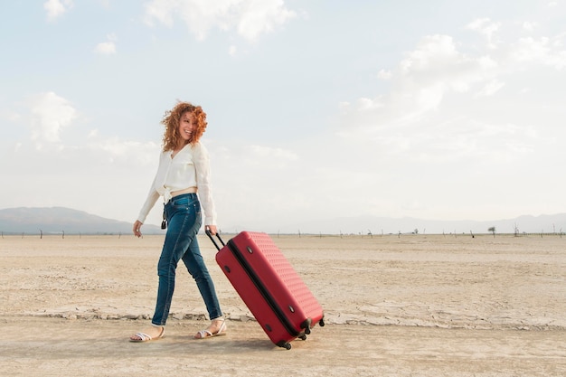 Low angle woman with luggage