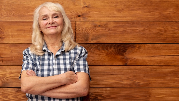 Low angle woman with wooden wall as background