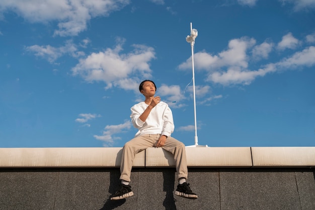 Free photo low angle young asian man with cancer