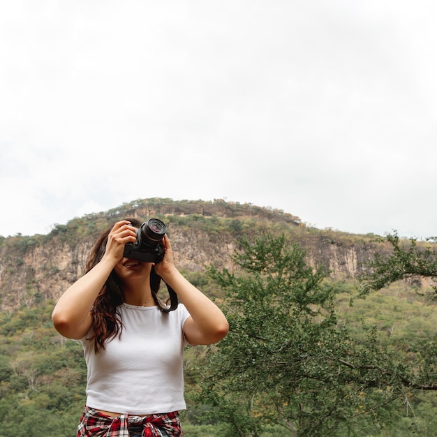 Low angle young female with camera