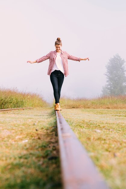 Low angle young girl balancing on railway 