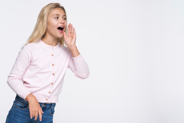 Free photo low angle young girl screaming with copy-space