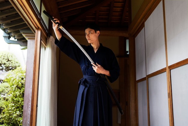 Low angle young man holding sword