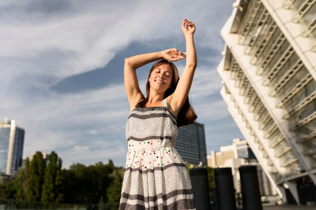 Low angle young woman smiling while posing