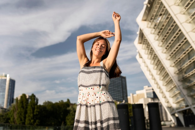 Low angle young woman smiling while posing