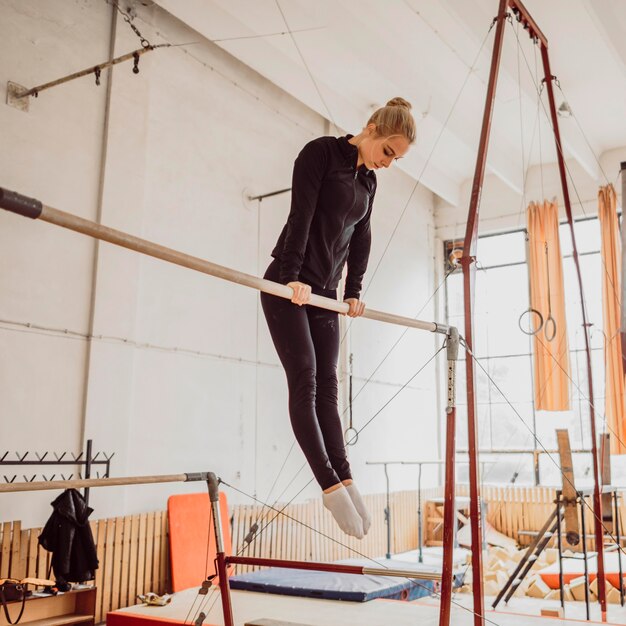 Low angle young woman training for gymnastics championship