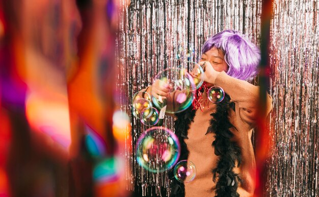 Low angle young woman with wig at carnival party