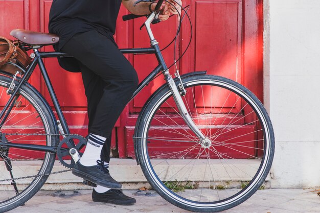 Low section of a man sitting on bicycle