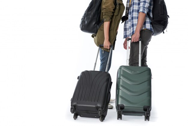 Low section of unrecognizable people with baggage and backpacks