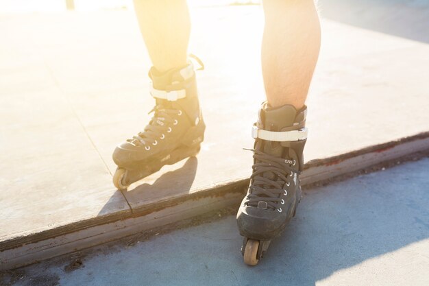 Free photo low section view of a man's feet with rollerskate