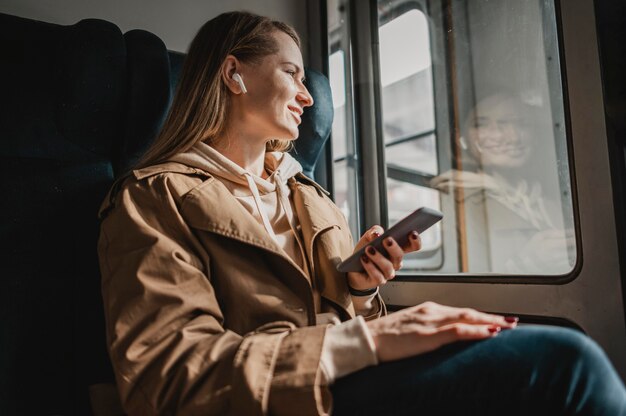 Low view female passenger listening to music