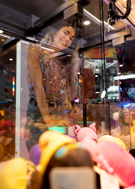 Free photo low view woman playing arcade machine