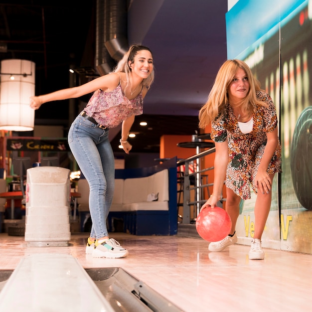 Low view women playing bowling