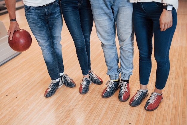 Foto gratuita parte inferiore dei corpi. vista ritagliata di persone al bowling pronte a divertirsi