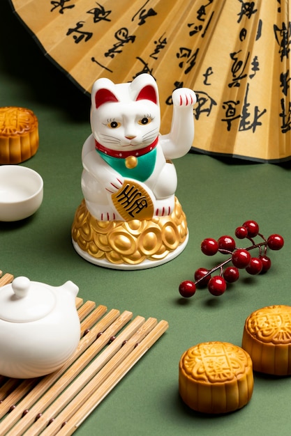 Free photo lucky cat with green background high angle