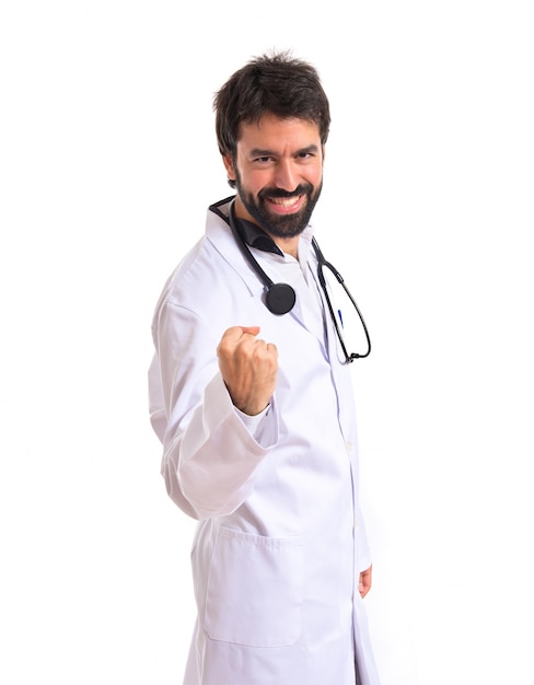 Lucky doctor over isolated white background