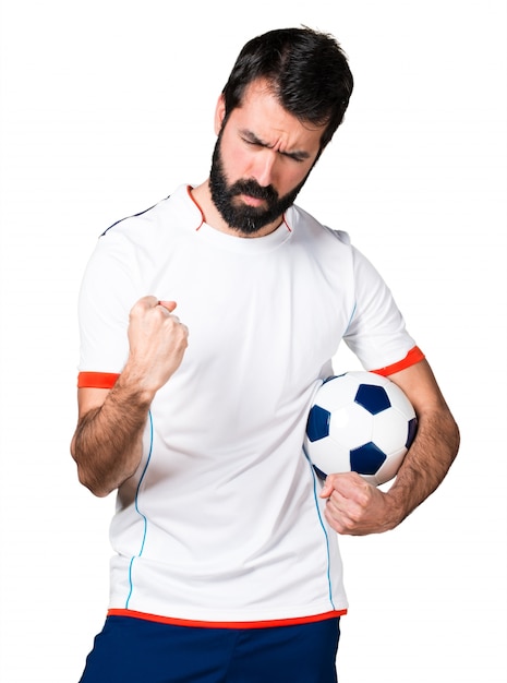 Lucky football player holding a soccer ball