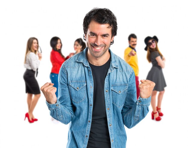 Lucky young man over isolated white background