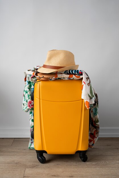 Luggage with hawaiian shirts with floral print and hat