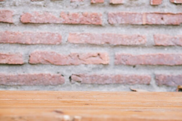 Lumber table near brick wall