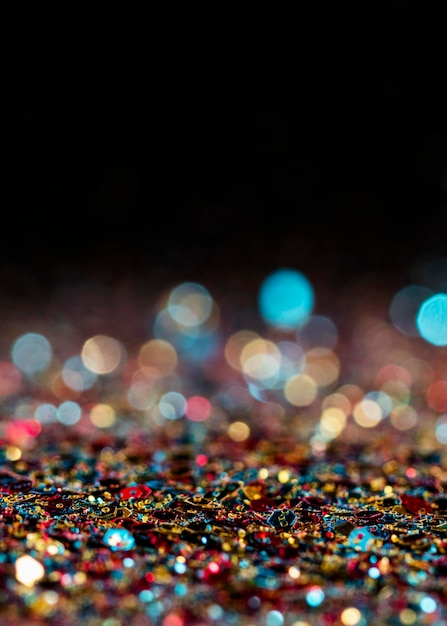 Free photo luminescent multicolored glitter with copy space