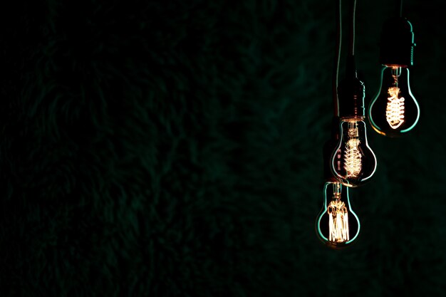 Luminous lamps hang in the dark. Decor and atmosphere concept.