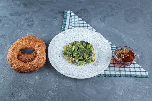 Lunch arrangement on folded tablecloth on marble table.