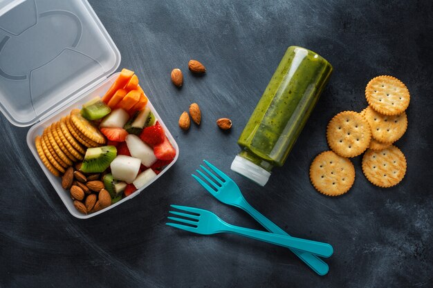 Lunch to go with fruits and vegetables in box. View from above.