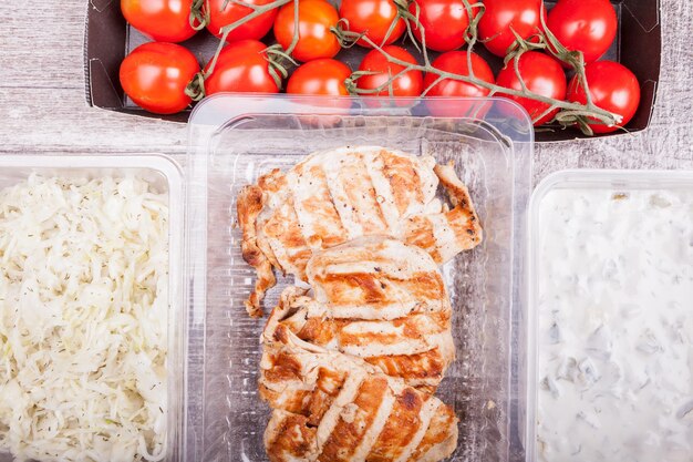 Lunch packed in different boxes. Fresh and healthy lifestyle. Wooden background