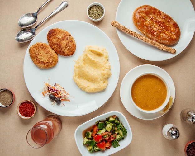 Lunch set  choban salad  lentil soup  cutlets withmushed potoato  compote  top view